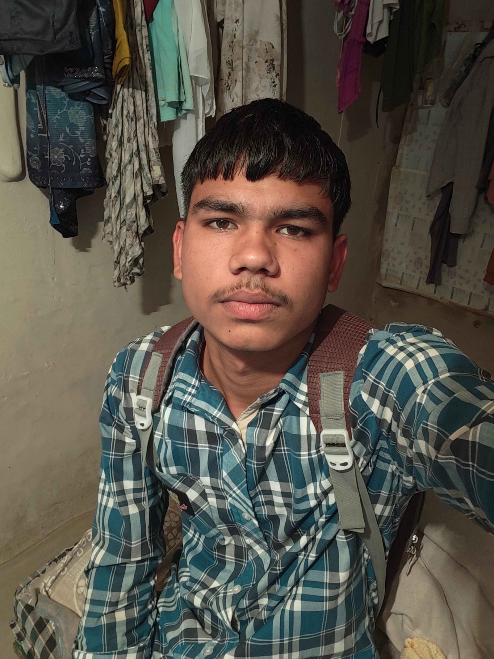 Sanjay Vaishya check shirt backpack room photo