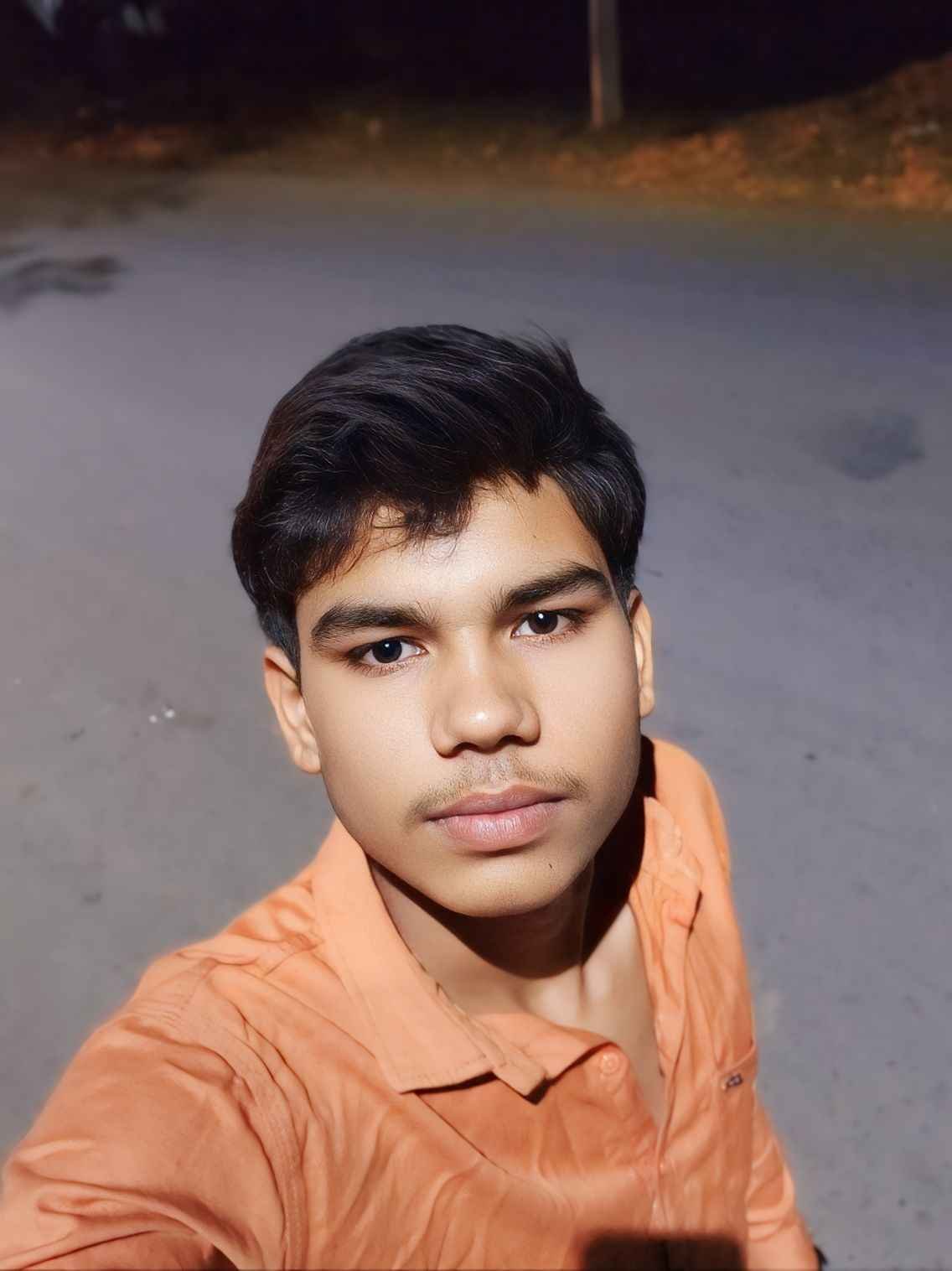 Sanjay Vaishya closeup selfie orange shirt photo